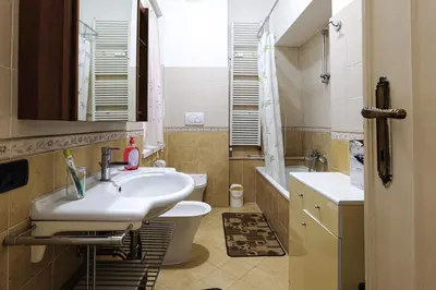 a bathroom with a sink and a toilet and a mirror at Appartamento a Roma a due passi da Trastevere in Rome