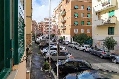 a row of parked cars on a city street at Appartamento a Roma a due passi da Trastevere in Rome