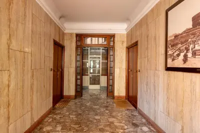 a hallway with wooden walls and a painting on the wall at Appartamento a Roma a due passi da Trastevere in Rome