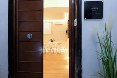 a door leading into a dining room with a table at The Brick Apartment by Nosdom Properties in Rome
