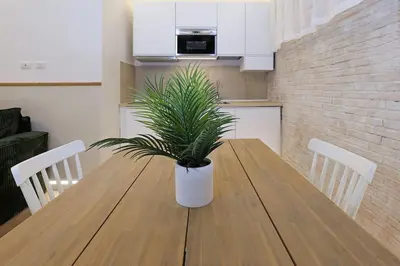a potted plant sitting on a wooden table in a kitchen at The Brick Apartment by Nosdom Properties in Rome