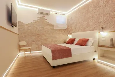 a bedroom with a bed and a brick wall at The Brick Apartment by Nosdom Properties in Rome