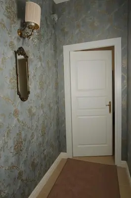 a white door in a room with wallpaper at Elegant Flat Spanish steps in Rome