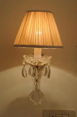a glass lamp with a light on a wall at Elegant Flat Spanish steps in Rome