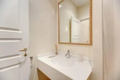 a white bathroom with a sink and a mirror at Elegant Flat Spanish steps in Rome