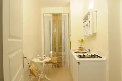 a white bathroom with a sink and a stove at Elegant Flat Spanish steps in Rome