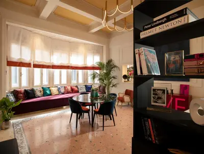 a living room with a table and a couch at Elizabeth Unique Apartments - a Member of Design Hotels in Rome