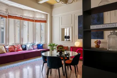 a living room with a table and a purple couch at Elizabeth Unique Apartments - a Member of Design Hotels in Rome