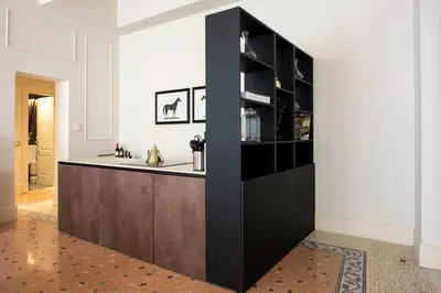 a kitchen with a dark wood island in a room at Elizabeth Unique Apartments - a Member of Design Hotels in Rome