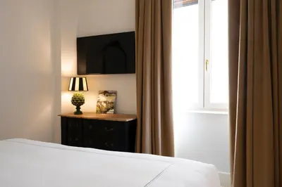 a bedroom with a bed and a window at Elizabeth Unique Apartments - a Member of Design Hotels in Rome