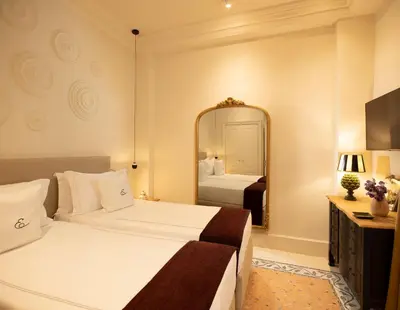 a hotel room with a bed and a mirror at Elizabeth Unique Apartments - a Member of Design Hotels in Rome