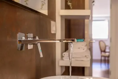 a sink with water coming out of a faucet at iFlat Bright Brand New 2-Bedroom Apt in Monti in Rome