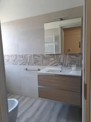 a bathroom with a sink and a mirror at Le tue vacanze a Roma-2 bagni-nuovo apt in Rome