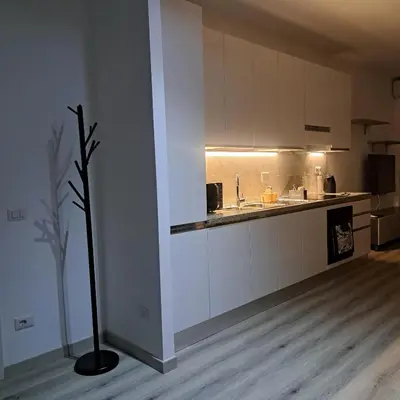 a kitchen with white cabinets and a vase in a room at Le tue vacanze a Roma-2 bagni-nuovo apt in Rome