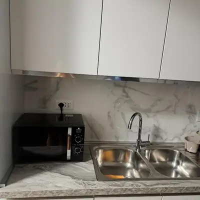 a kitchen with a sink and a counter top at Le tue vacanze a Roma-2 bagni-nuovo apt in Rome