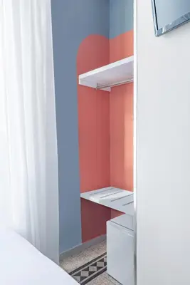 a closet with red walls and a white curtain at Hotel Infinito - Gruppo BLAM HOTELS in Rome