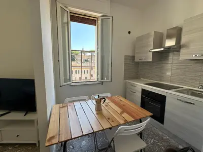 a kitchen with a wooden table and a window at Smart Home in Rome