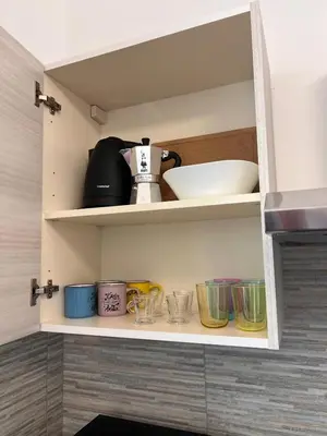 a cupboard with some cups and bowls on it at Smart Home in Rome