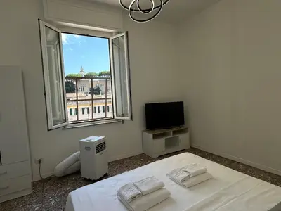 a white room with a bed and a window at Smart Home in Rome