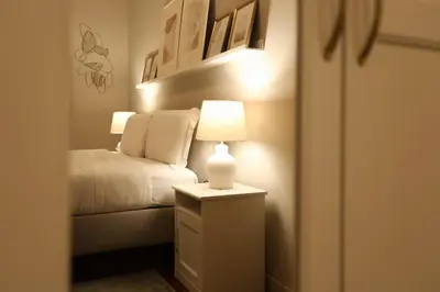 a bedroom with a bed and a lamp on a night stand at Piramide Deluxe Apartment in Rome
