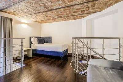 a room with a bed and two bunk beds at Home at Rome Luxury Navona Suites in Rome