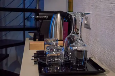 a tray with two glasses and a wine bottle at Home at Rome Luxury Navona Suites in Rome