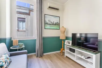 a living room with a couch and a tv at iFlat Retro Style Apartment near the Vatican in Rome