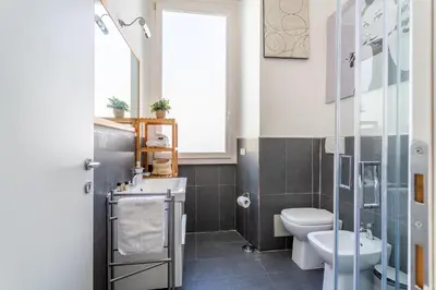 a bathroom with a sink toilet and a window at iFlat Retro Style Apartment near the Vatican in Rome