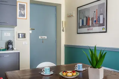 a kitchen with a table with a plate of fruit on it at iFlat Retro Style Apartment near the Vatican in Rome