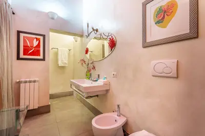 a bathroom with a sink and a toilet and a mirror at iFlat Baroque Apartment in Campo de' Fiori in Rome