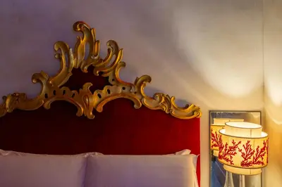 a bedroom with a bed with a red head board at iFlat Baroque Apartment in Campo de' Fiori in Rome