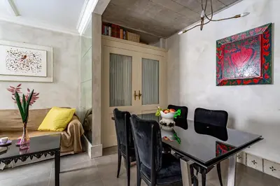 a dining room with a table and chairs at iFlat Baroque Apartment in Campo de' Fiori in Rome