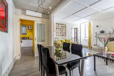 a dining room and living room with a table and chairs at iFlat Baroque Apartment in Campo de' Fiori in Rome
