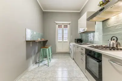 a kitchen with a stove and a sink at House Grimaldi in Rome