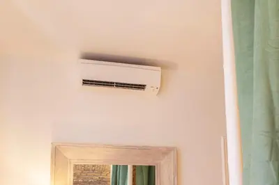 a pillow sitting on a bench in front of a window at Vatican Borgo Pio Splendid Apartment in Rome