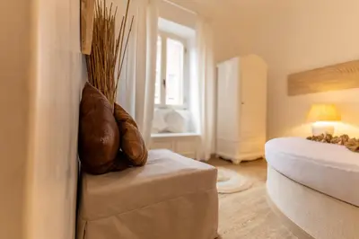 a kitchen with a wooden table with a vase on it at Vatican Borgo Pio Splendid Apartment in Rome