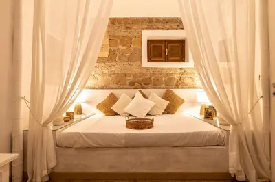 a bedroom with a green bed with blue curtains at Vatican Borgo Pio Splendid Apartment in Rome