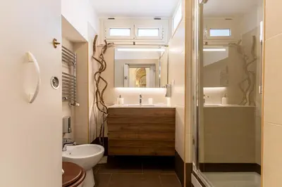 a bathroom with a white sink on a counter at Vatican Borgo Pio Splendid Apartment in Rome
