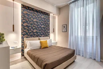 a bedroom with a bed with a large window at Pretorius Charming New Apt in Rome