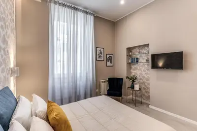 a bedroom with a large bed and a tv at Pretorius Charming New Apt in Rome