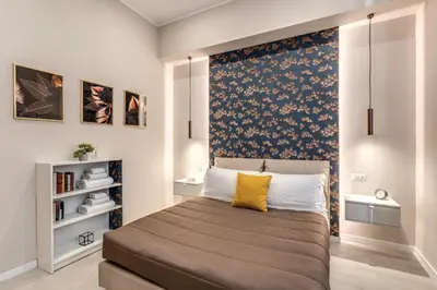 a bedroom with a large bed with a yellow pillow at Pretorius Charming New Apt in Rome