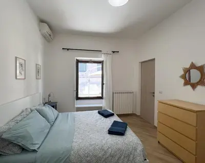 a bedroom with a bed with blue pillows on it at Urban Retreat in Rome