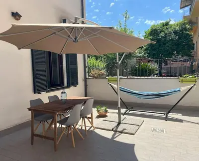 a table and a hammock under an umbrella at Urban Retreat in Rome