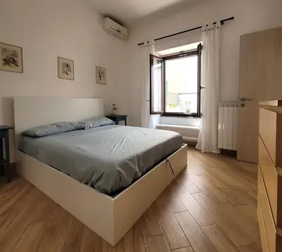 a bedroom with a large bed with a window at Urban Retreat in Rome