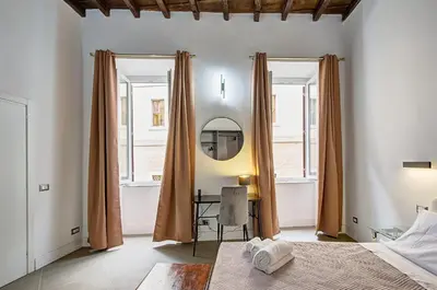 a bedroom with a bed and a mirror at Domus Capitolina Campo De' Fiori in Rome
