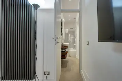 a white bathroom with a toilet and a mirror at Domus Capitolina Campo De' Fiori in Rome