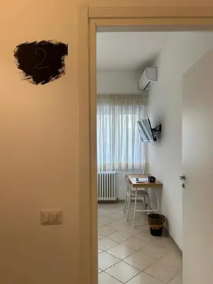 a room with a table and a desk with a computer at Peppe's Bed in Rome
