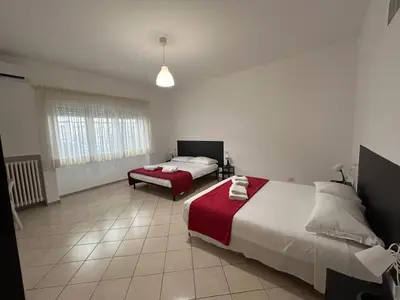 a bedroom with two beds and a window at Peppe's Bed in Rome