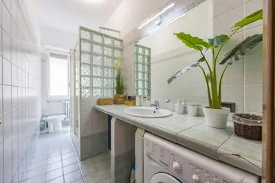 a bathroom with a sink and a toilet at Apartment Metro San Paolo -Air Conditioning-WIFI-TV55