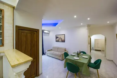 a living room with a table and a couch at Apartment Metro San Paolo -Air Conditioning-WIFI-TV55